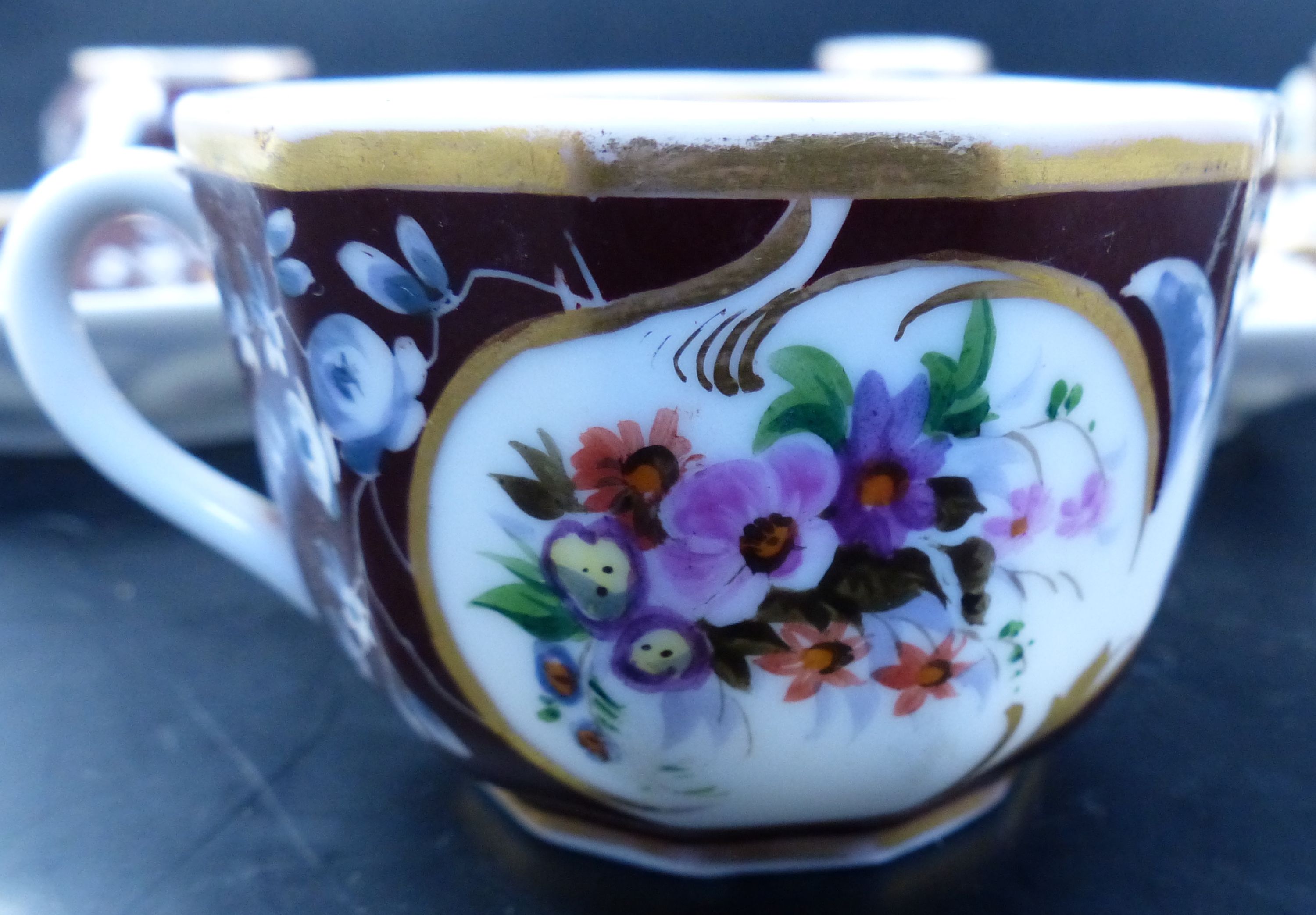 A set of seven Continental porcelain tea cups and saucers